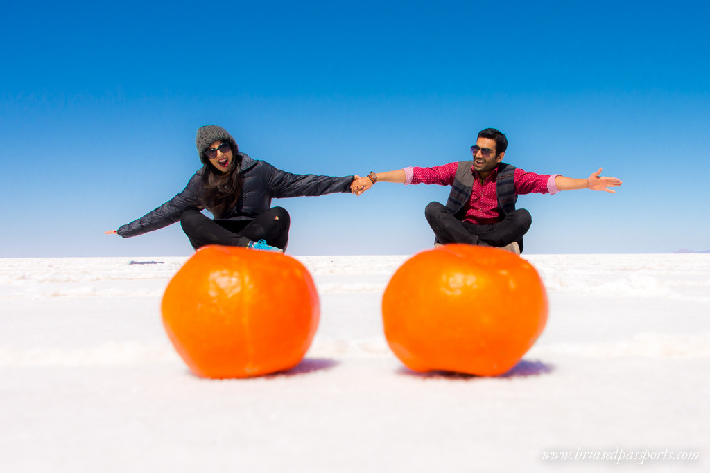 A couple doing perspective shots in Salar De Uyuni Bolivia
