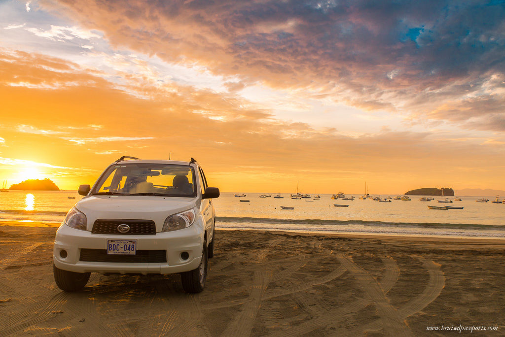 Playa Del Coco Costa Rica sunset at beach with car